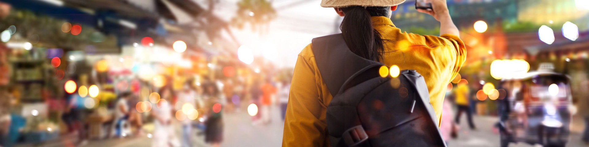 Female tourist traveling backpacker and take a photo in jatujak, chatuchak outdoor market in Bangkok, Thailand