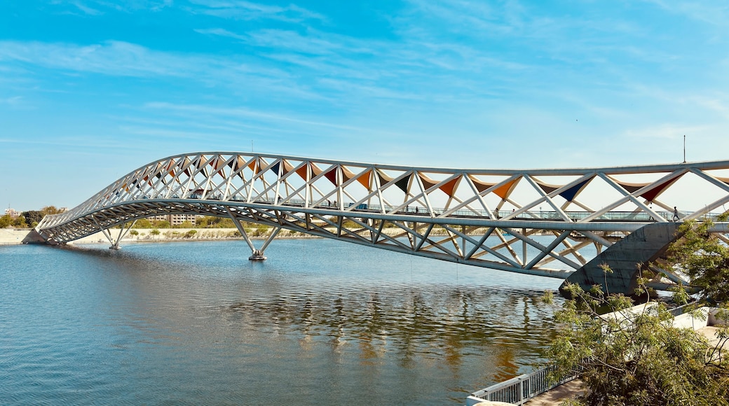 Experience the Atal Pedestrian Bridge at Sabarmati Riverfront, Ahmedabad, with this stunning landscape photo. Showcasing architectural brilliance against serene river views.