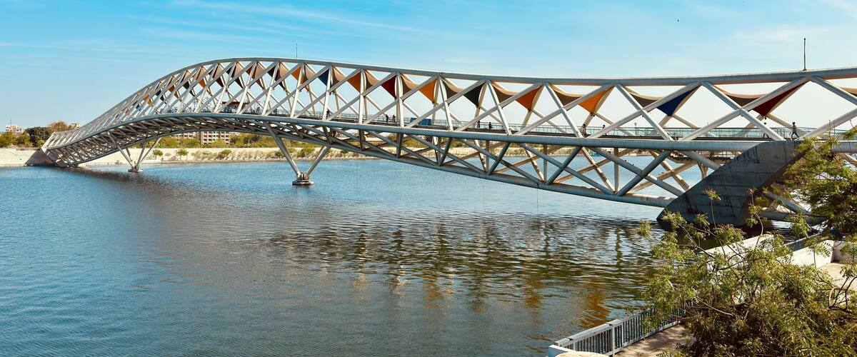 Experience the Atal Pedestrian Bridge at Sabarmati Riverfront, Ahmedabad, with this stunning landscape photo. Showcasing architectural brilliance against serene river views.