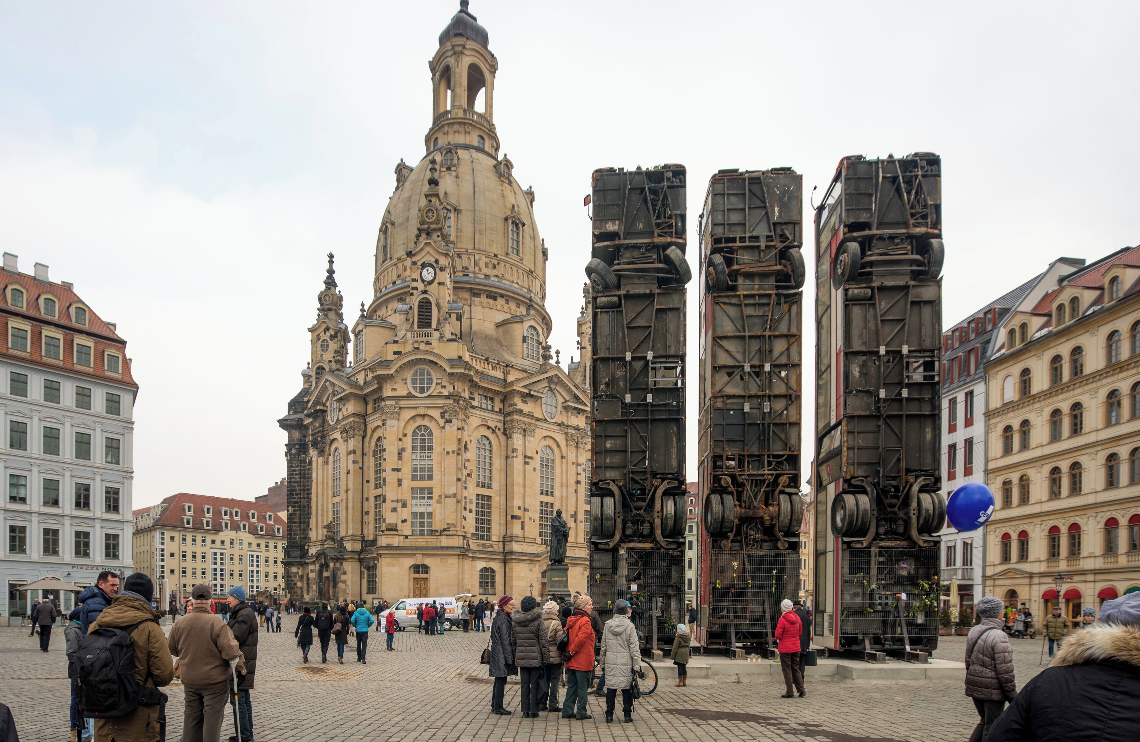 Shows the sculpture "Monument" by Manaf Halbouni in front of the Frauenkirche, Dresden, Germany