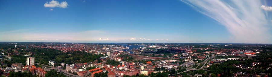 A cityscape with a river, bridges, and a large stadium.