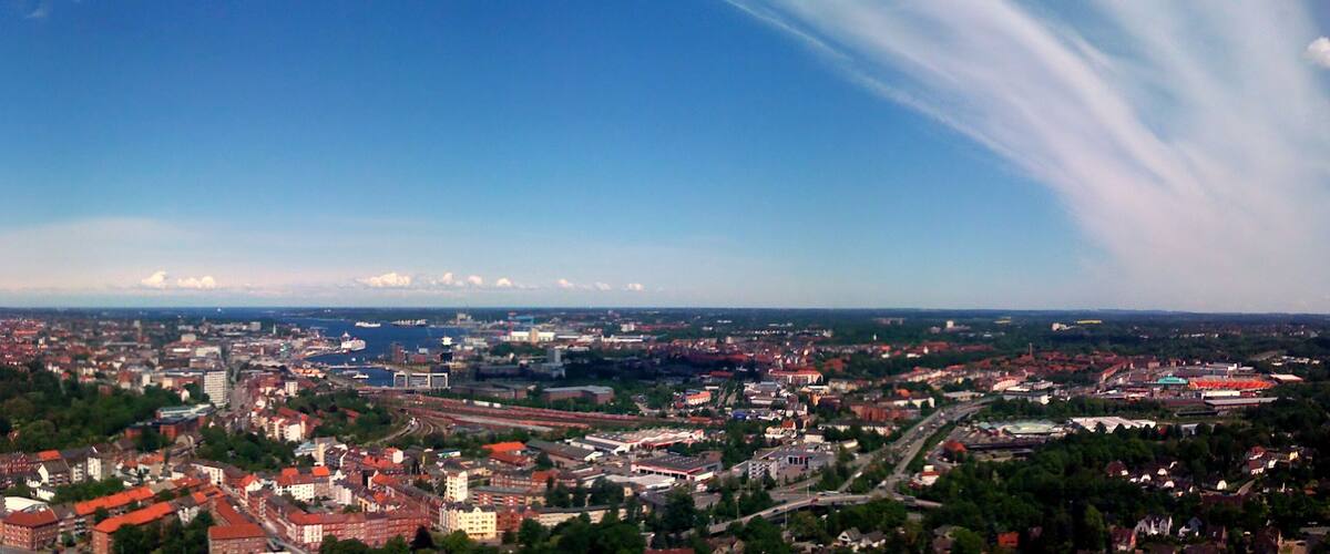 A cityscape with a river, bridges, and a large stadium.