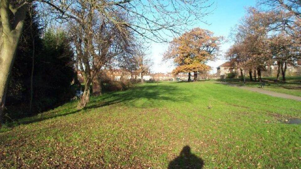 Burnt Oak: Watling Park. Viewed looking northwards with a tributary brook of the Silk Stream flowing in the channel to the left.