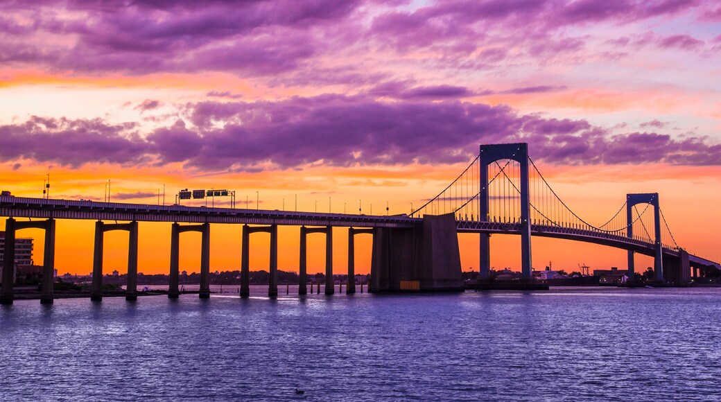 New York City Throgs Neck Bridge from Queens NYC to the Bronx with colorful sunset sky