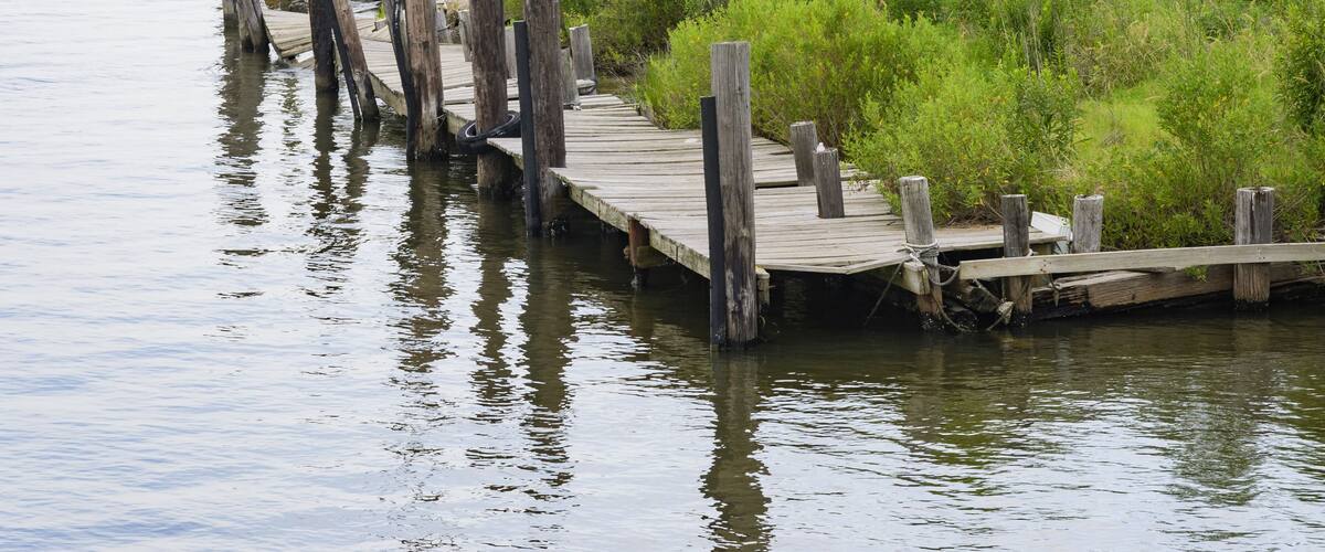 Dilapidated pier alongside land on Lake ST. Catherine in Louisiana