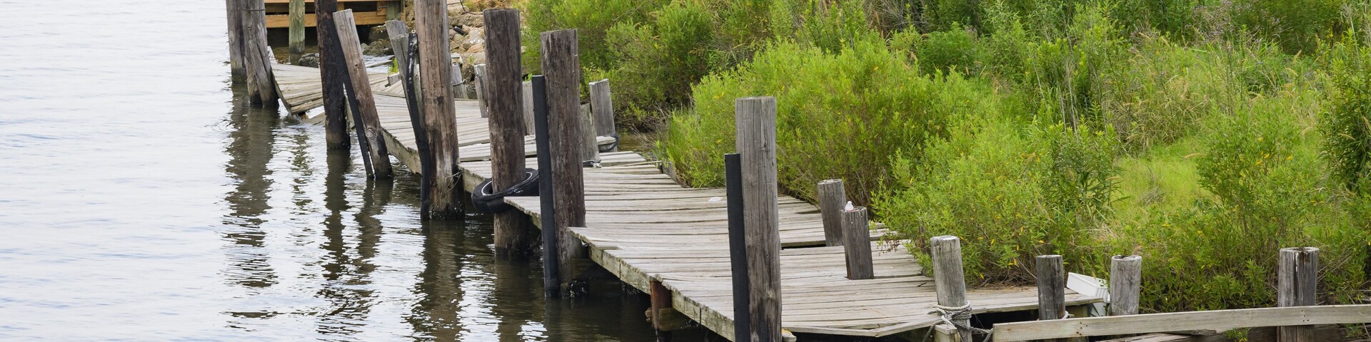 Dilapidated pier alongside land on Lake ST. Catherine in Louisiana