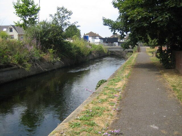 Villiers Road bridge over Hogsmill, Kingston upon Thames Dead straight reach of Hogsmill, looking downstream along hard bank.