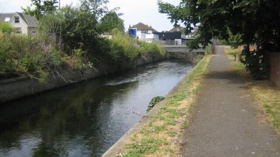 Villiers Road bridge over Hogsmill, Kingston upon Thames Dead straight reach of Hogsmill, looking downstream along hard bank.