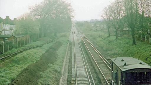 SE from Gloucester Road up the railway on a wintry Sunday, 1977. View towards New Malden and Waterloo: ex-LSWR Waterloo - Kingston etc. line. The line was in occupation by Engineers for renovation
