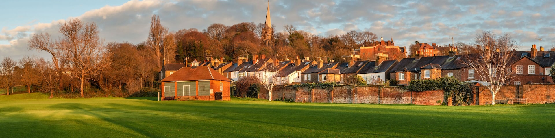 A golf course with houses in the background.