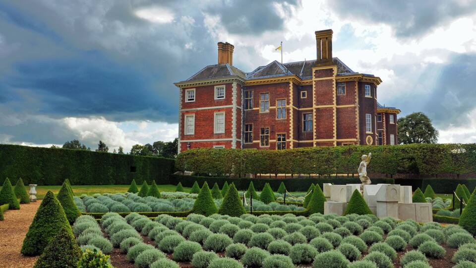 A view of Stuart-era Ham House from across the adjacent gardens, laid out in neat orderly rows.