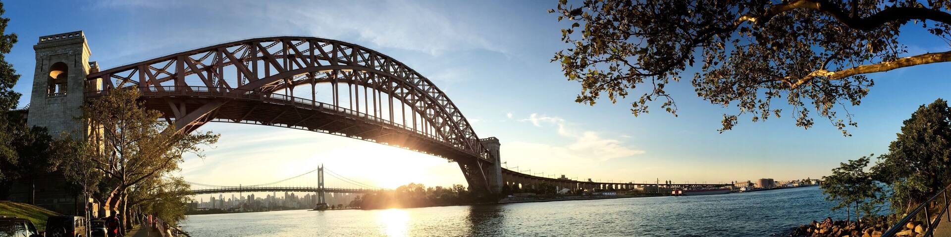 The Hell Gate Bridge over the river with sunset sky in panorama shot, Astoria park, Astoria, Queens, New York
