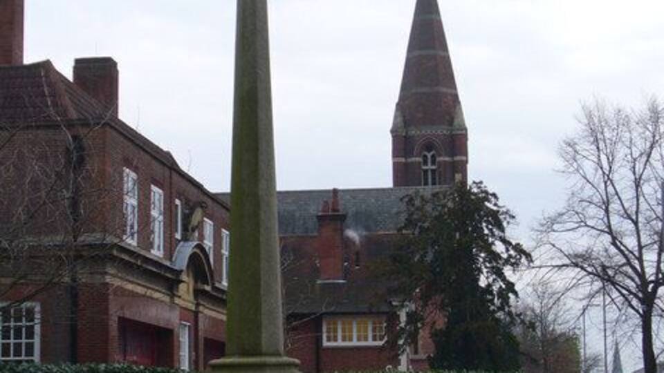 Surbiton War Memorial Set in a memorial garden on the Ewell Road. Beyond are a fire station and church spire.