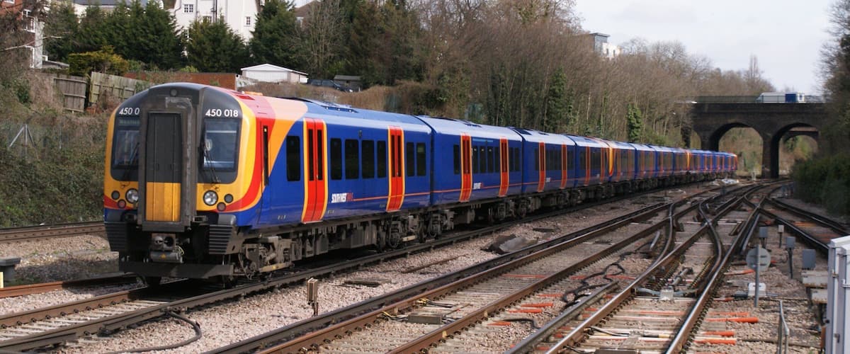 Siemens (Wein & Uerdingen) Class 450 "Desiro" 750 v dc 3rd rail 4-car emu No.450 018 of South West Trains in SWT outer-suburban livery speeds through Surbiton on a Waterloo - Basingstoke service, 03/09.