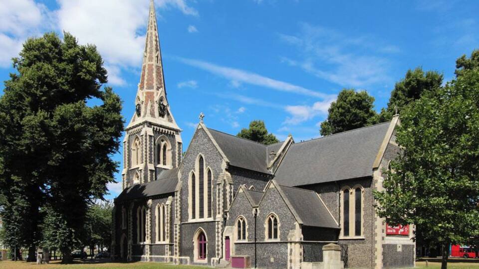 A church with a tall steeple and Gothic architecture.