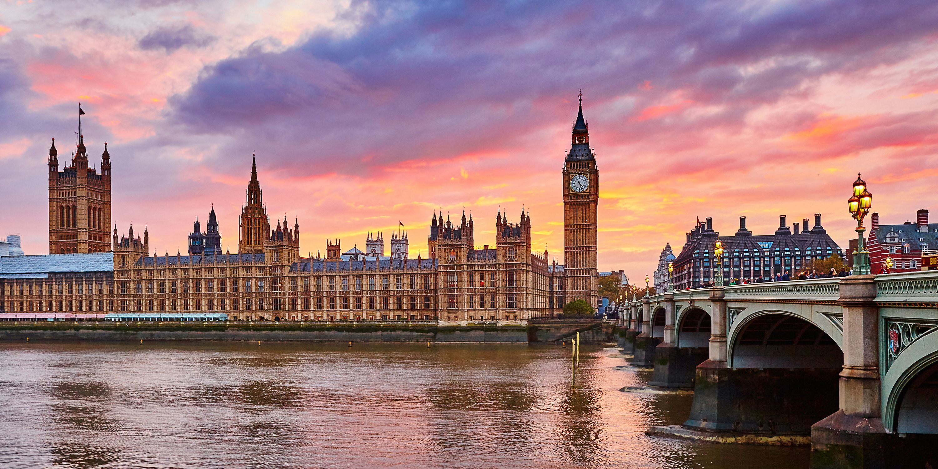 The Houses of Parliament and Big Ben in London, with the River Thames in the foreground.