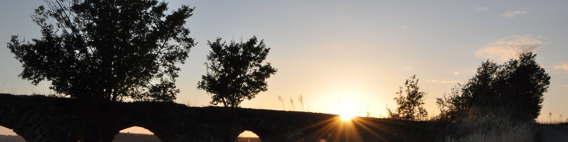 roman aqueduct ruins in monte romano italy at sunset