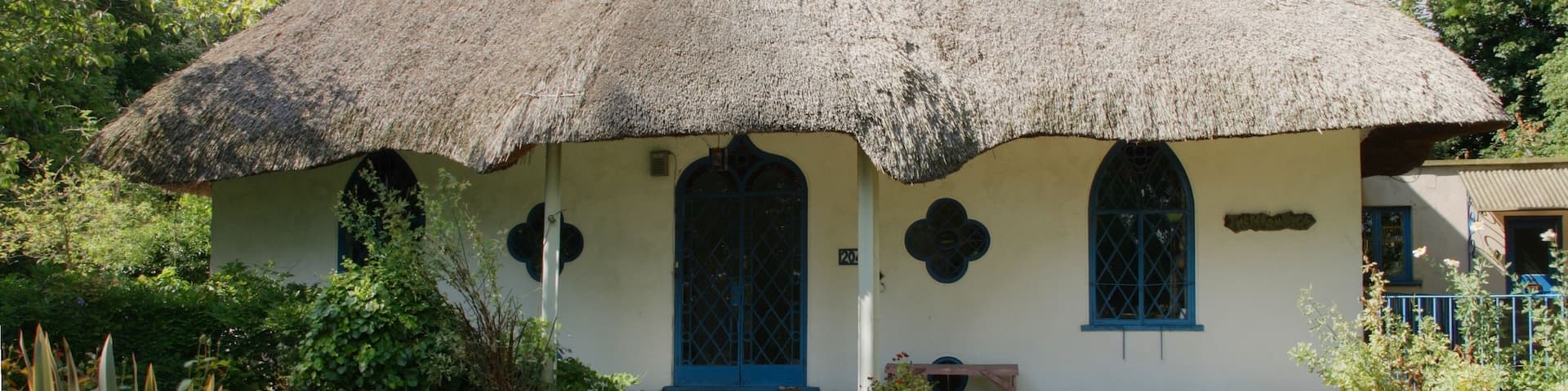 The Hermitage -Hanwell W7 This cottage orné was built by the rector George Henry Glasse in 1809 on the site of a previous house called the Elms. Later it became the head quarters for the Selborne Society. Nikolaus Pevsner describes it thus: “a peach of an early c19 Gothic thatched cottage with two pointed windows, a quatrefoil, and an ogee arched door, all on a minute scale. Inside, an octagonal hall and reception room” (Pevsner, London 3: North West). It is a Grade II Listed Building Behind the cottage lies a spring, which may be the origin behind the 'well' being incorporated into the local place name of Hanwell.