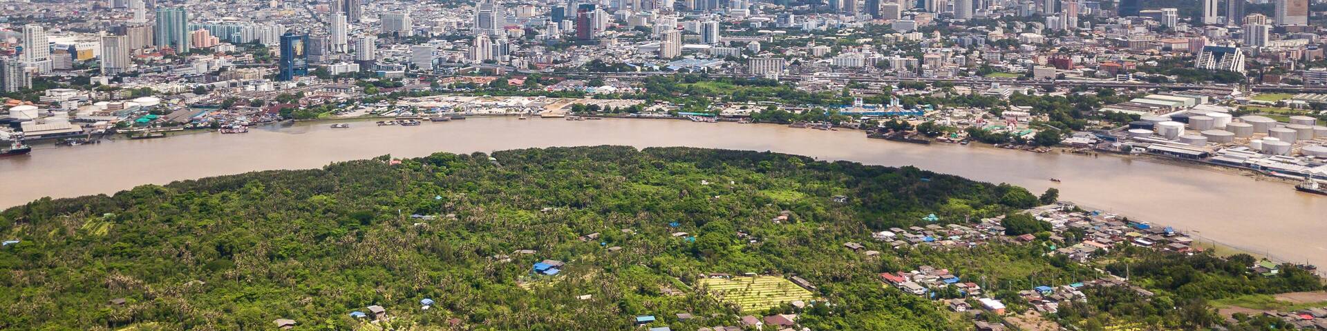 Aerial View of Bangkok skyline and view of Chao Phraya River View from green zone in Bang Krachao, Phra Pradaeng, Samut Prakan Province.