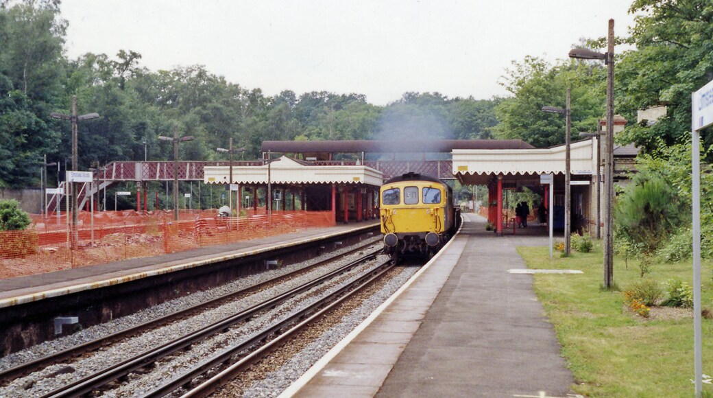 Elmstead Woods station, 1991. View NW, towards London: ex-SE&CR Charing Cross/Cannon Street - Orpington, Sevenoaks, Tonbridge, Ashford etc.. Work is evidently under way on the station and a Class 33 Diesel approaches on a Down Engineer's train.