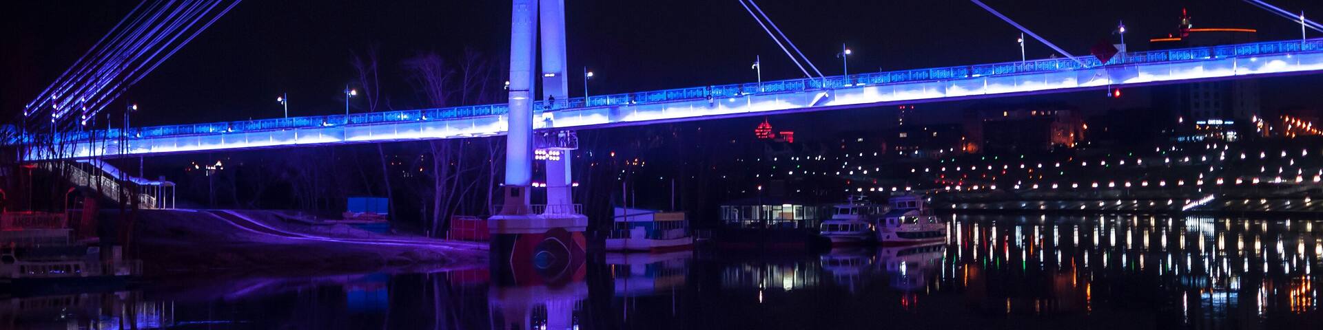 Tyumen, Russia, on April 15, 2020: The pedestrian cable-stayed bridge in Tyumen at night