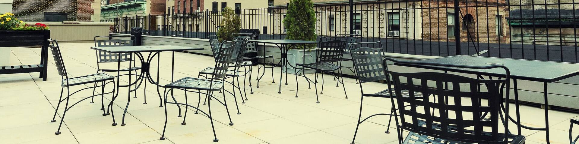 Rooftop cafe overlooking the Empire state building, Manhattan, New York City. Vintage processed.