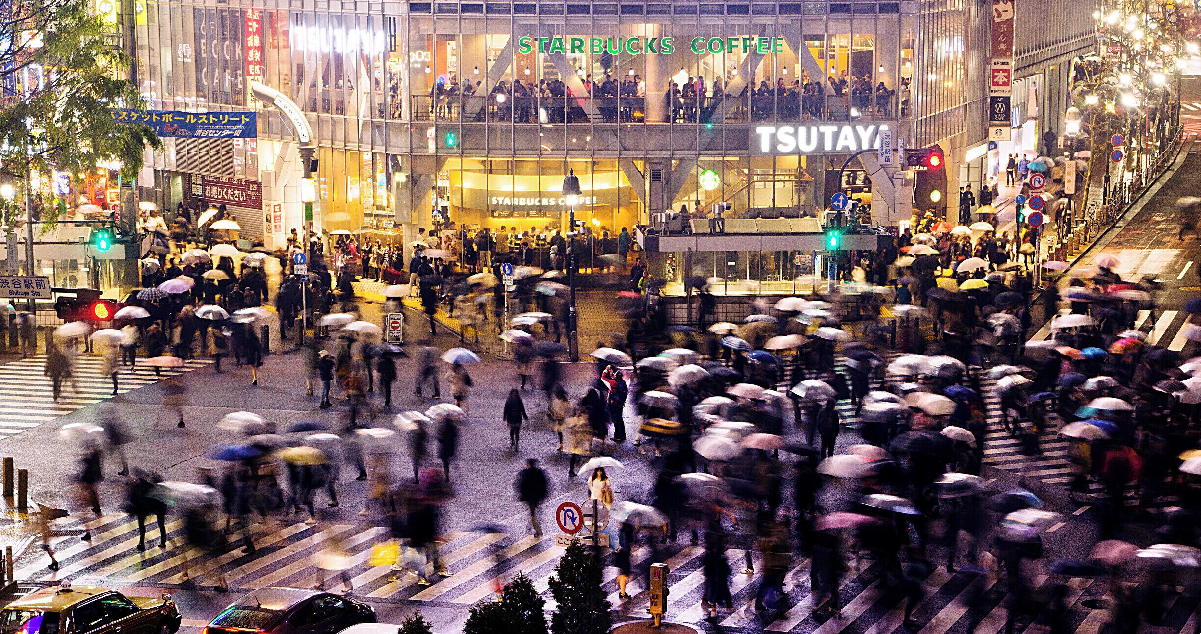 The ‪‎Shibuya Scramble‬ crossing is heavily decorated by giant video screens and gets flooded by pedestrians each time the crossing light turns green.

This shot of a tourist standing still taking pictures and a lady in white pausing just momentarily at the crossroad helped create the juxtaposition needed for the busy scene. Can you believe this station handles over 3 million people a day?