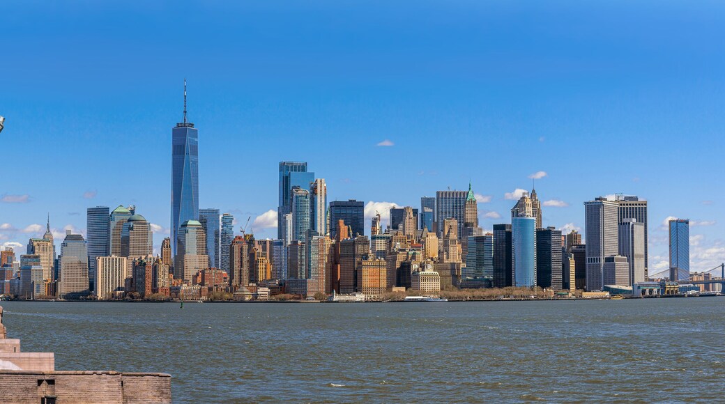 The Statue of Liberty over the Panorama Scene of New York cityscape river side which location is lower manhattan, United state of America, USA, Architecture and building with tourist concept