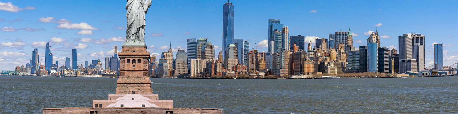 The Statue of Liberty over the Panorama Scene of New York cityscape river side which location is lower manhattan, United state of America, USA, Architecture and building with tourist concept
