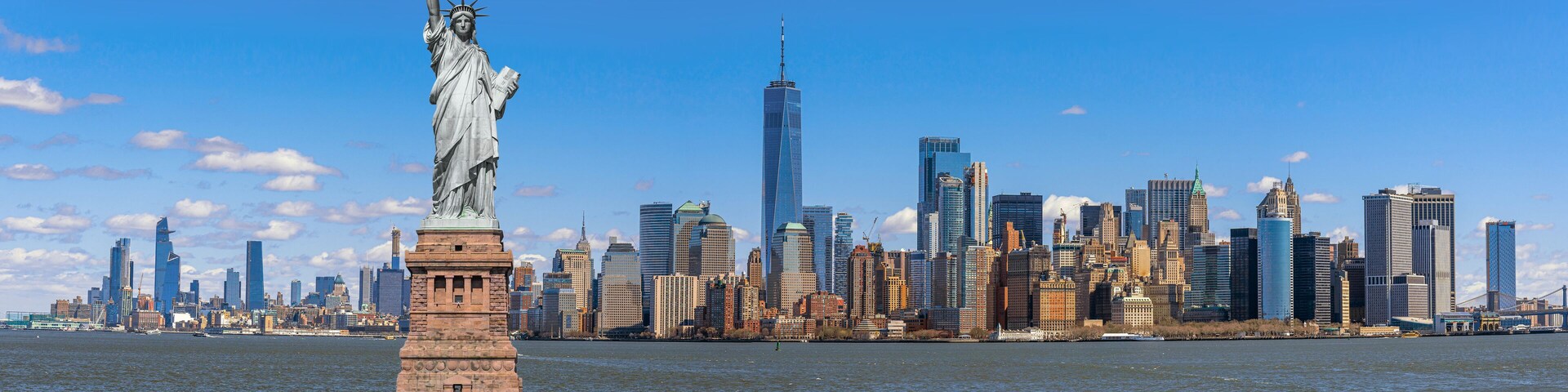 The Statue of Liberty over the Panorama Scene of New York cityscape river side which location is lower manhattan, United state of America, USA, Architecture and building with tourist concept