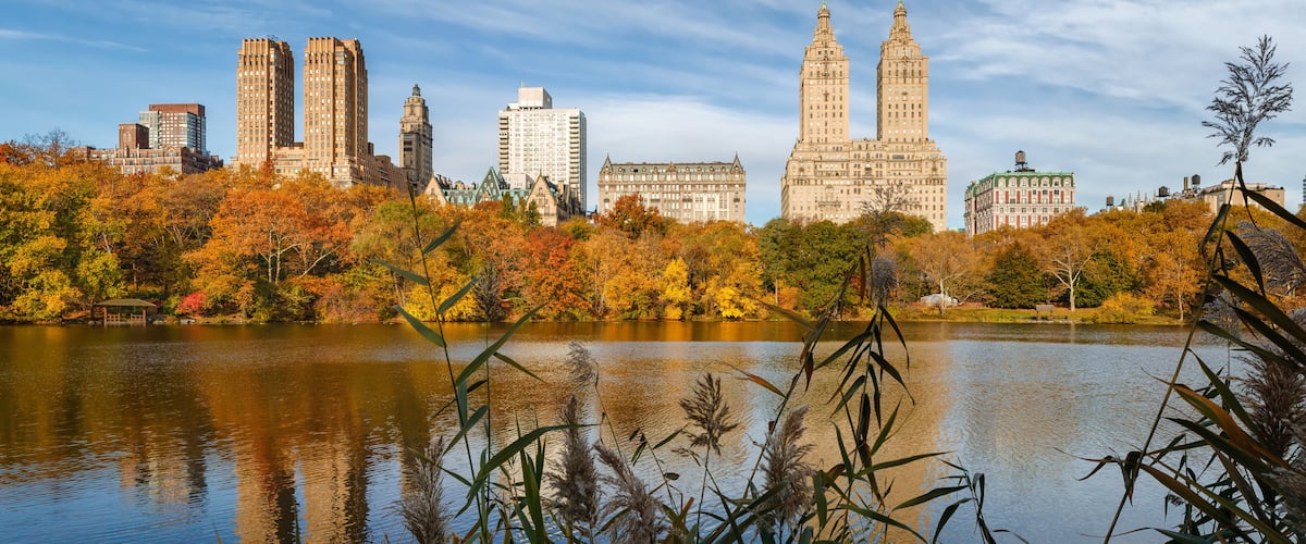 The Lake in Central Park in autumn with reflection of the Upper West Side buildings. Central Park West Historic District, Manhattan, New York City