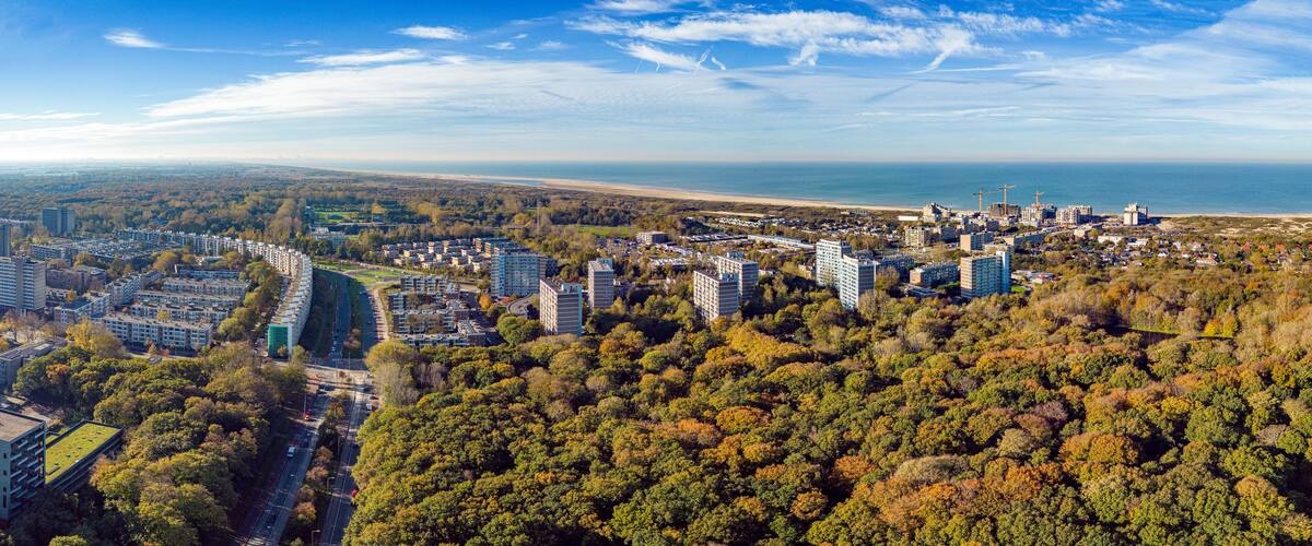 Aerial panorama photo of the seaside resort Kijkduin with the adjacent neighborhoods and the Meer en Bos park in the foreground in November 2022.