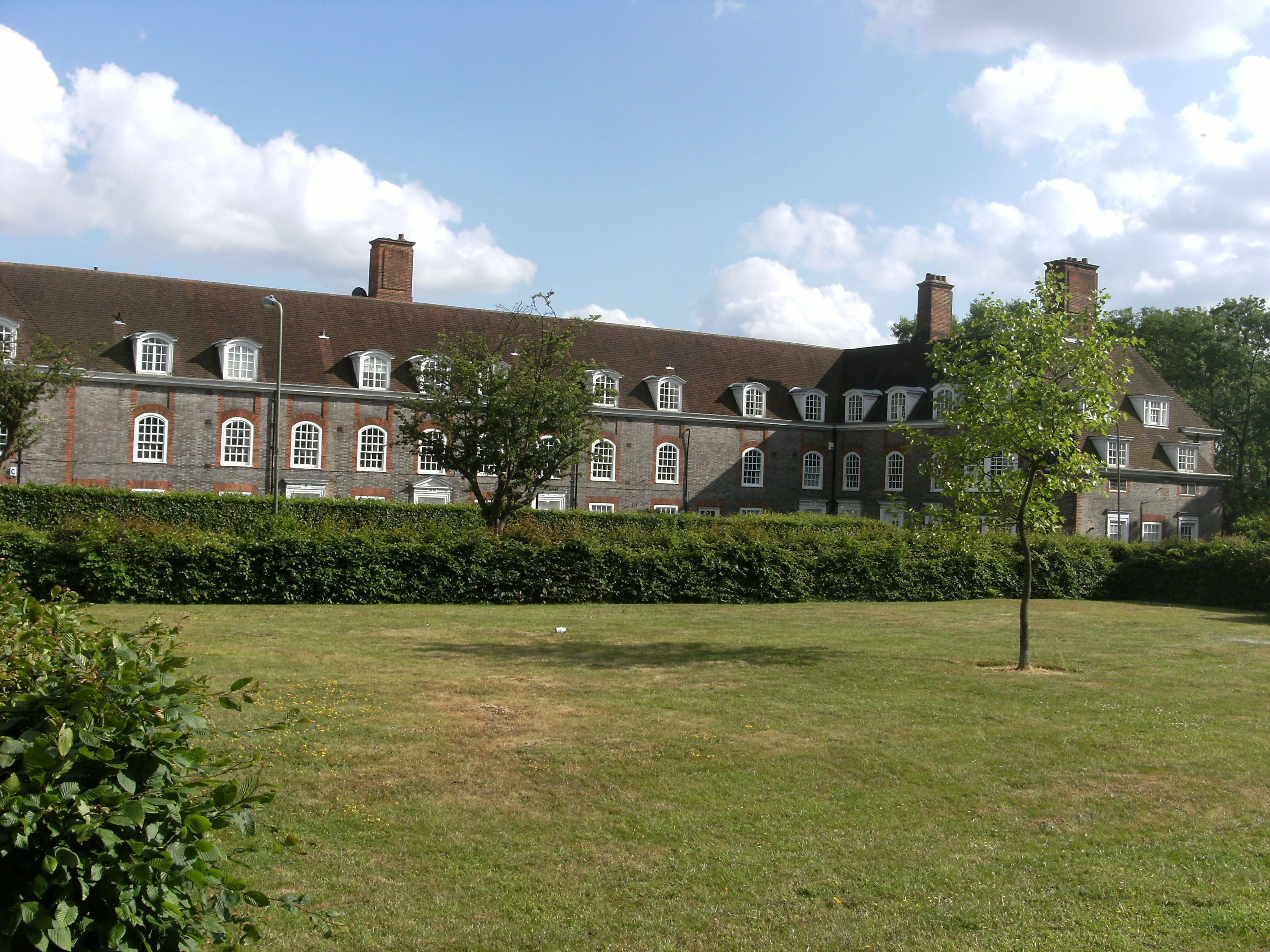 Looking towards houses on South Square from the grounds of St Jude's Church, Hampstead Garden Suburb, London NW11.
