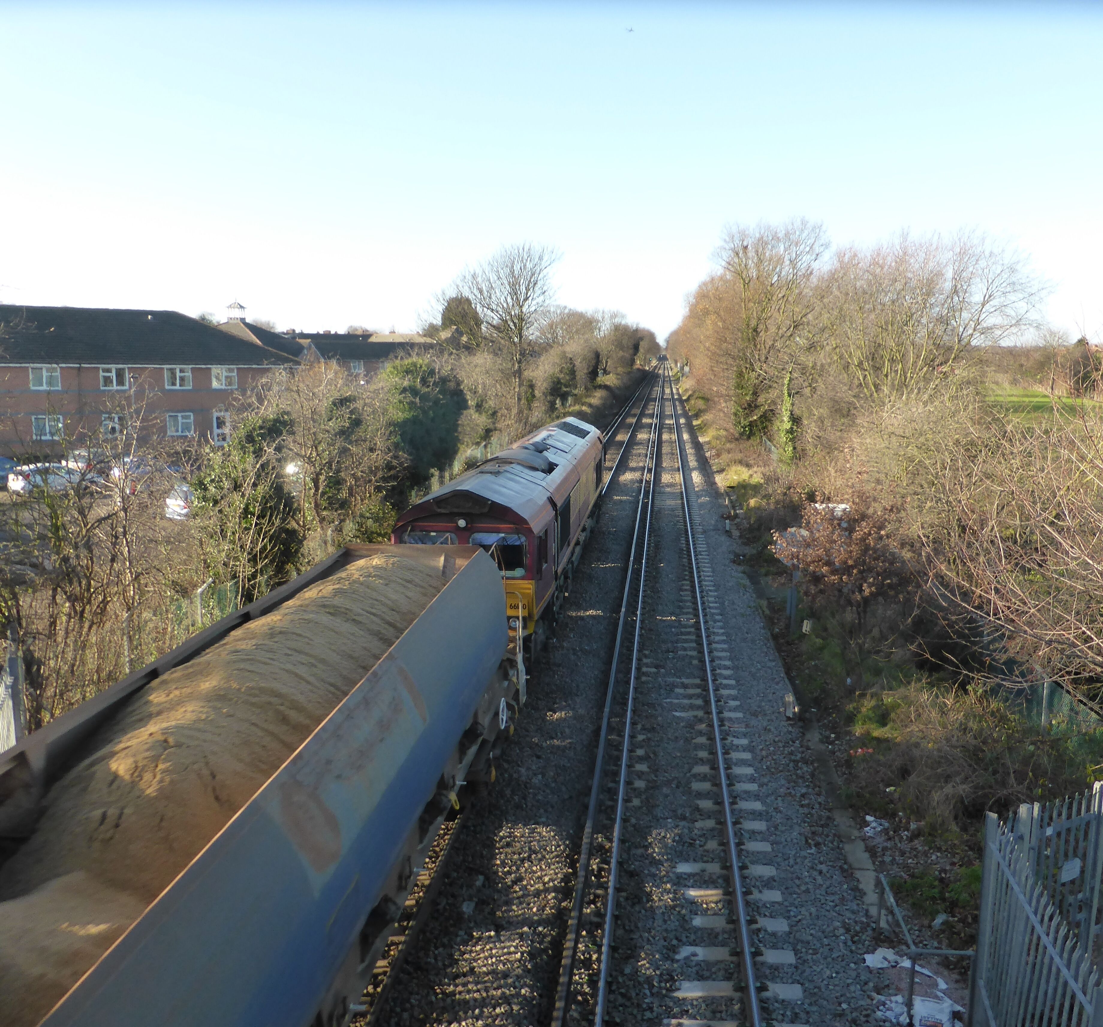 Class 66 (JT42CWR) number 66160 built by General Motors Electro-Motive Division, London, Ontario, Canada in 1999 and unloaded from the Heavy Lift Ship MV Fairmast at Newport Docks on 19 October 1999 seen here in EWS livery with the Angerstein Wharf Tarmac to Acton T.C. freight train 693V on 19 December 2013