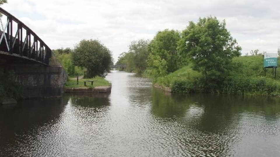 Bridge to Slough Arm, Grand Union Canal. The footbridge gives access from the towpath of the Grand Union Canal to that along its Slough Arm, straight ahead in the photo. See 422229 for a view in January 1977 - mainly different in this spring photo with leaves on the trees looking more pleasant than the earlier one in winter with bare branches.