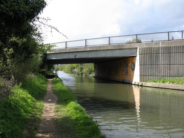 Kensington Road Bridge, Paddington Arm, Grand Union Canal This is the east face of the bridge. The drawings underneath are not casual graffiti, but are murals painted by pupils of a local primary school. The bridge carries Kensington Road, a motor road of local importance connecting Northolt with Southall.