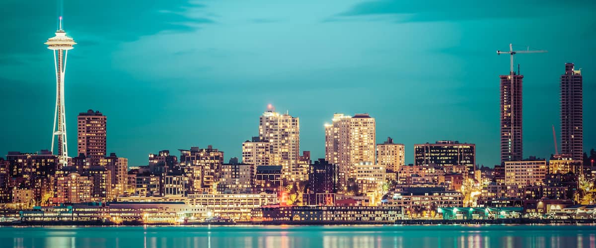 A city skyline with a prominent tower, several high-rise buildings, and a waterfront.