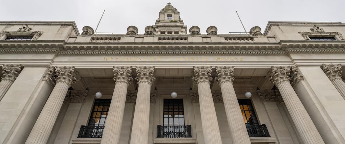 The Westminster Council House with classical architecture, including Corinthian columns and a triangular pediment.