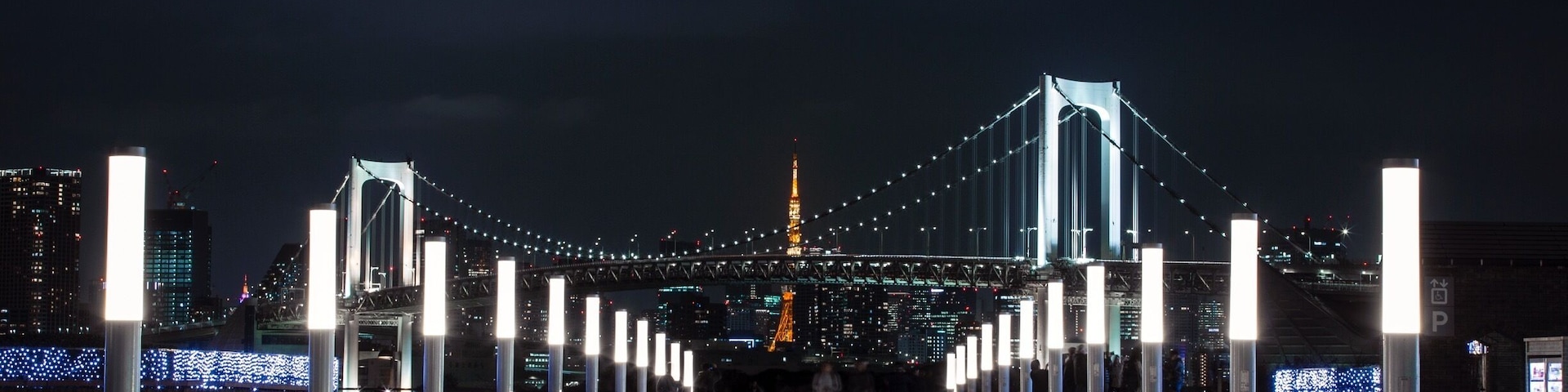 Tokyo Tower And The Rainbow Bridge as viewed from Daiba City, Tokyo.