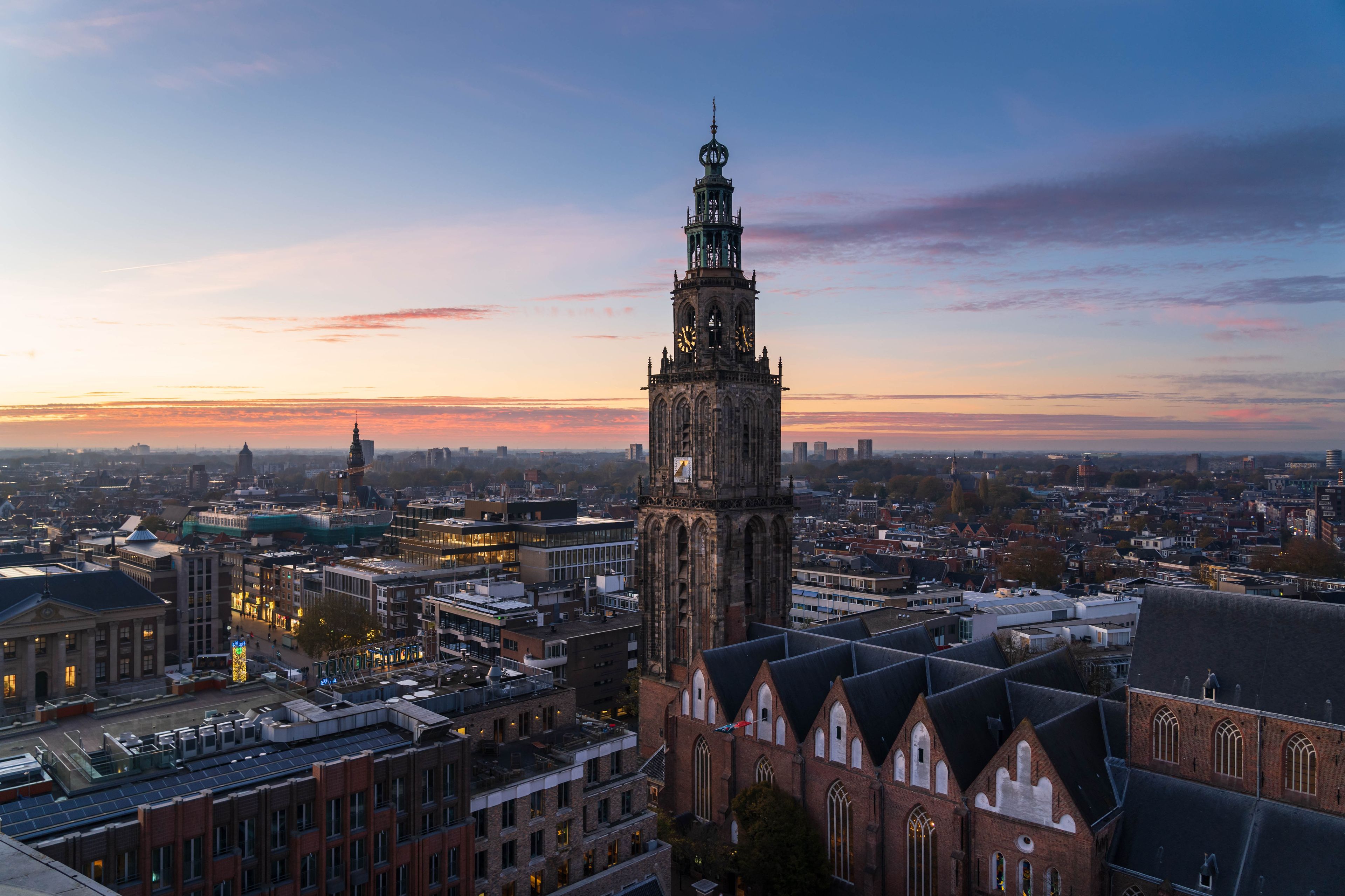 A cityscape with a prominent church tower and surrounding buildings.