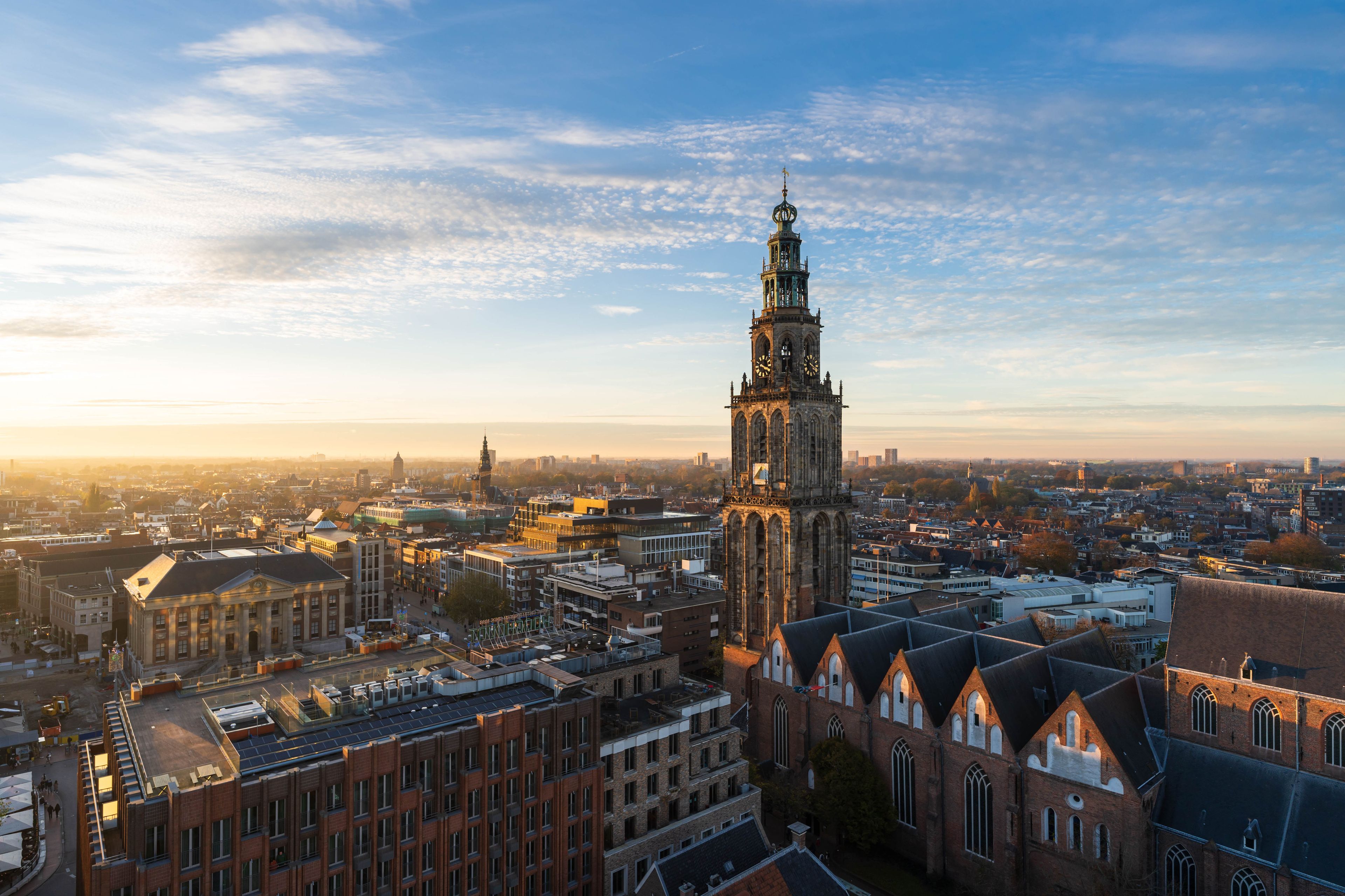 A cityscape with a prominent tower and surrounding buildings.