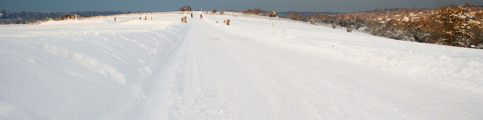 Fun in the Snow In the distance, families, complete with sledges, are making the most of the snow on the top of Farthing Downs, Surrey.
