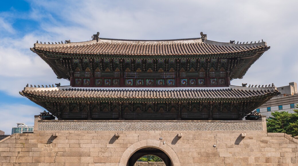 A traditional Korean gate with ornate decorations and a tiled roof.