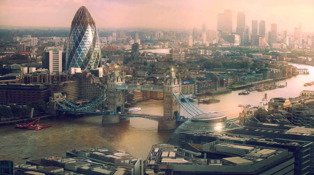 London view at sunset. Panorama include river Thames, Tower bridge and City of London and Canary Wharf buildings.