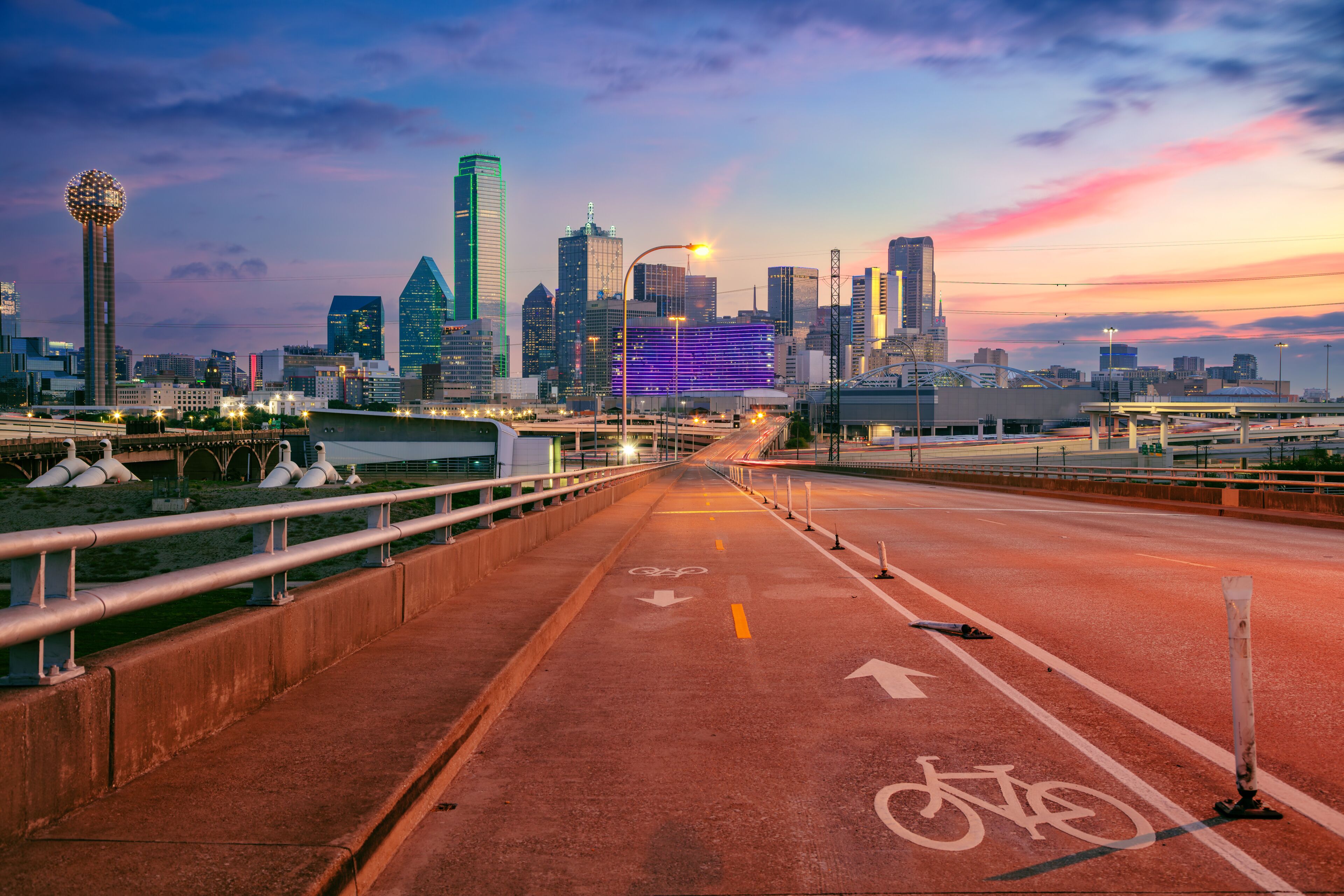 Dallas, Texas, USA. Cityscape image of downtown Dallas, Texas with highway and bike trail leading in to the city at beautiful sunrise.