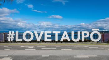 Hashtag Love Taupo sign in front of Lake Taupo in New Zealand.