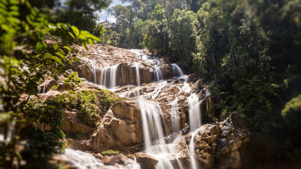 Scenery of Sungai Pandan Water Fall. Long exposure photography of a rainforest water fall. Waterfall in tropical forest at Malaysia. Beautiful waterfall in the forest. Soft water flow.