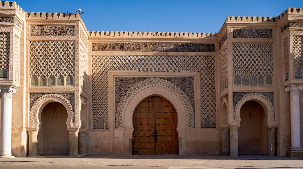 A historic building with intricate tile work and a large wooden door.