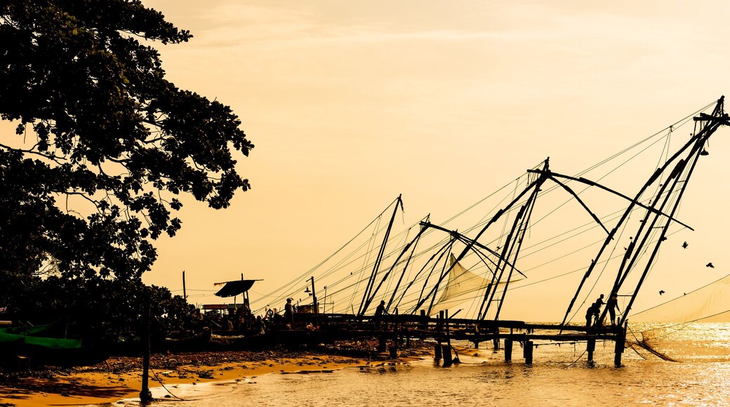 Panoramic silhouette of chinese fishnets on sunset at Fort Kochi, Kerala, India.