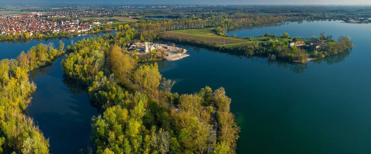 A river winding through a town with a castle on an island.